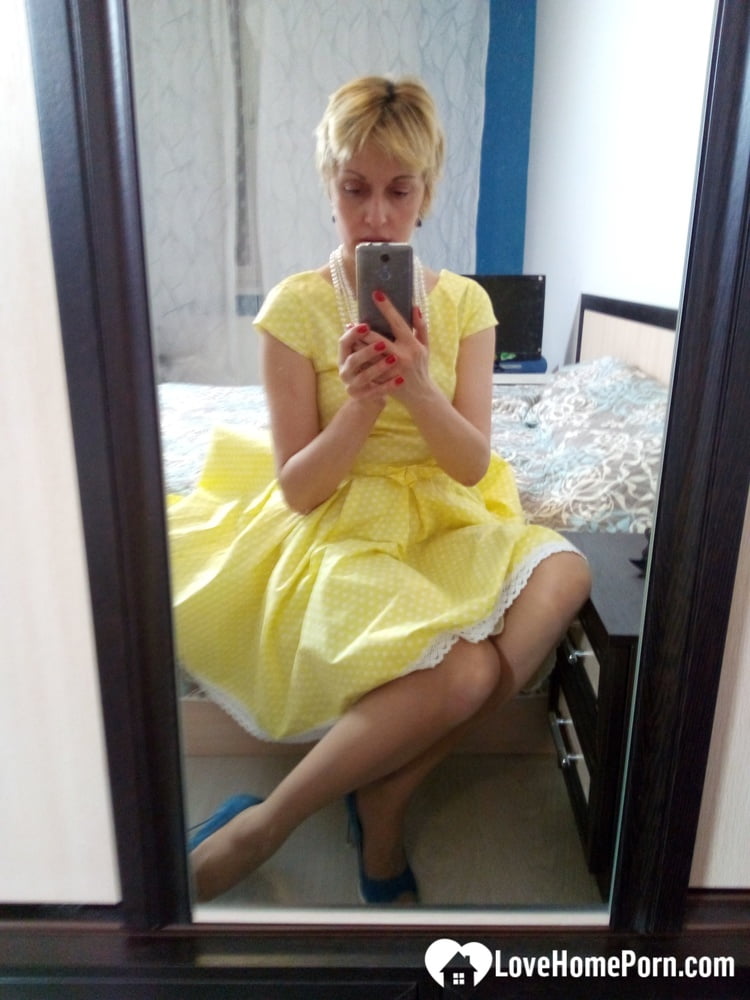 Stunning MILF puts on a yellow dress - 29 Photos 