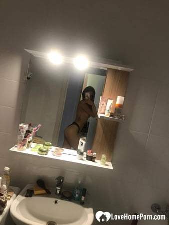 hot schoolgirl reveals her tits in the mirror         