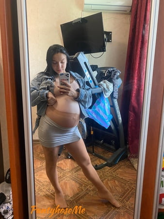 pregnant brunette in sheer pantyhose         