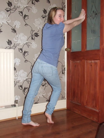 cute blonde posing in jeans and shirt         