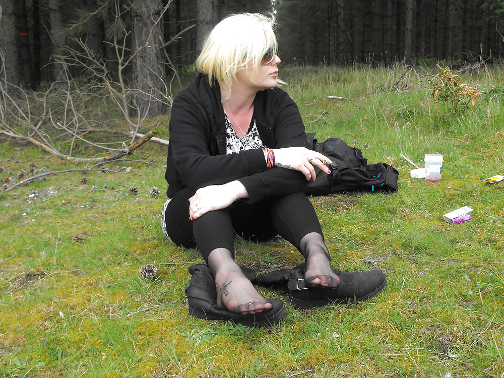 Em showing her sexy feet in the forest in black tights porn pictures