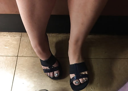 Wife's sexy feet under the table