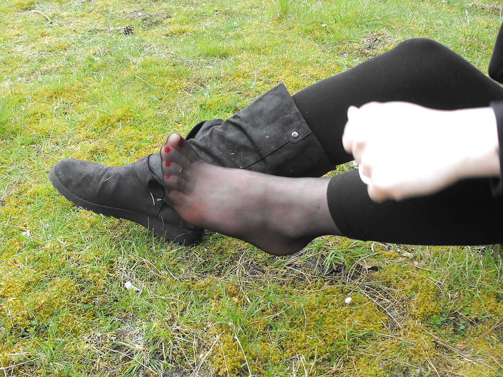 Em showing her sexy feet in the forest in black tights porn pictures